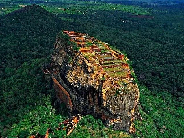 Aerial view of Sigiriya Rock Fortress revealing the ancient ruins on top.